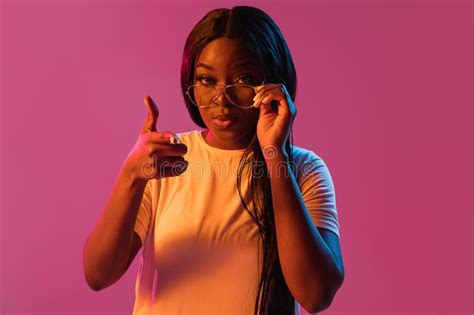 African Young Womans Portrait On Pink Studio Background In Neon