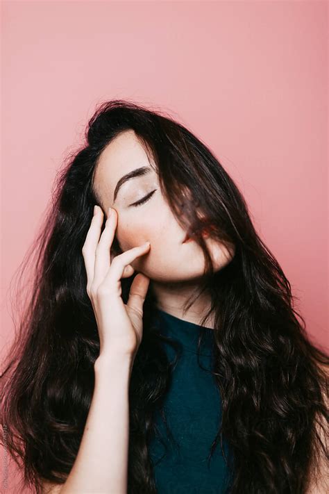 Woman Touching Her Face With Closed Eyes By Stocksy Contributor