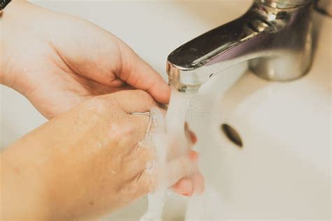 A Woman Washing Her Hands In The Bathroom At Home Stock Image Image