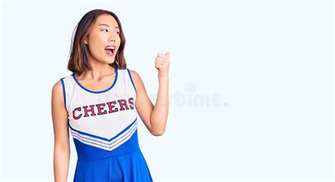 Young Beautiful Chinese Girl Wearing Cheerleader Uniform Smiling With