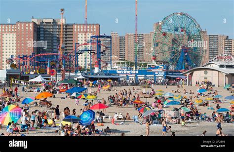 Coney Island beach with the boardwalk and Luna Park rides in the ...