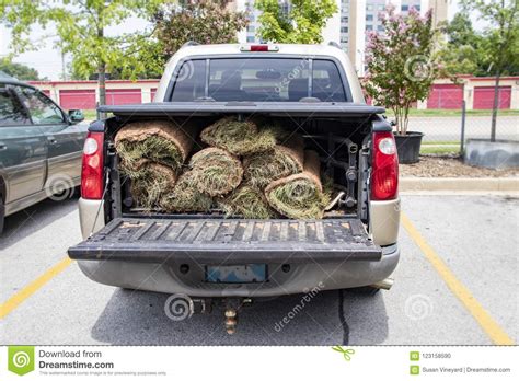 Close-up of Back of Pickup Truck with Bed Protector and Rolls of Sod in the Back with the ...