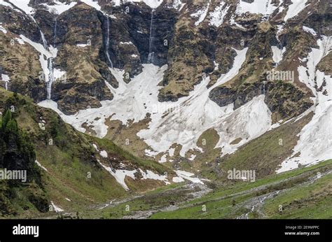 waterfalls with snow in the mountains Stock Photo - Alamy