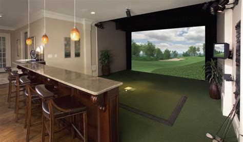 A Golf Simulator Is Set Up In The Middle Of A Room With Bar Stools