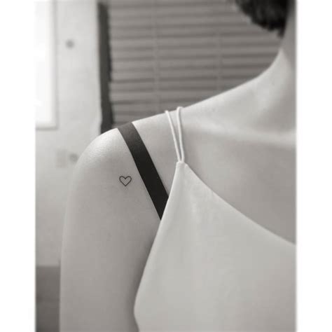 Tiny Minimalistic Heart Tattoo Located On The Shoulder