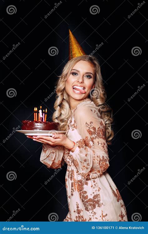 Portrait Of A Young Funny Beautiful Blond Girl Holding Birthday Cake With Candles On Black