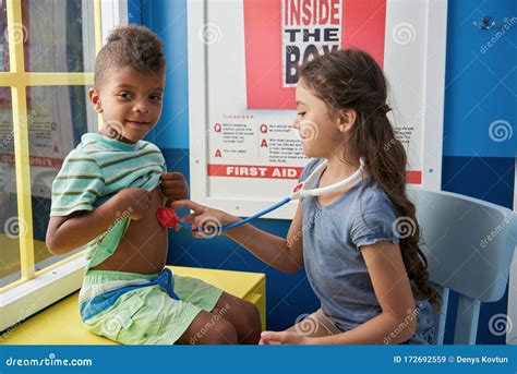 Two Children Playing Doctor In Playroom Stock Image Image Of Happy