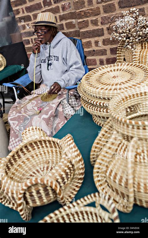 Gullah woman weaving sweetgrass baskets at the Historic Charleston City ...