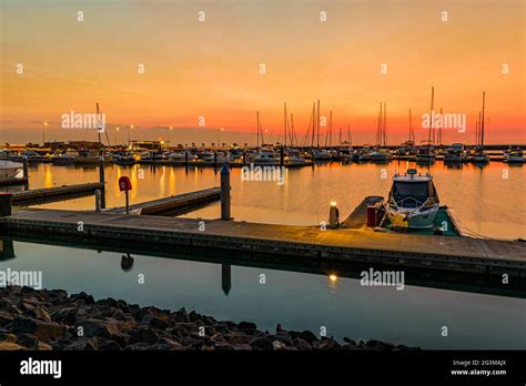 Evening harbour view with sunset Stock Photo - Alamy