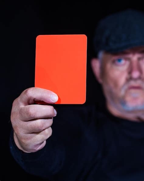 Premium Photo | A referee shows a red card