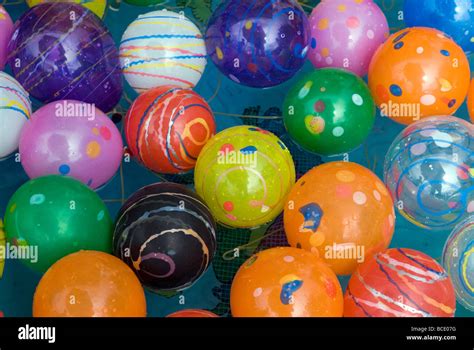 Collection Of Multi Colored Plastic Balls Floating In A Tub Of Water