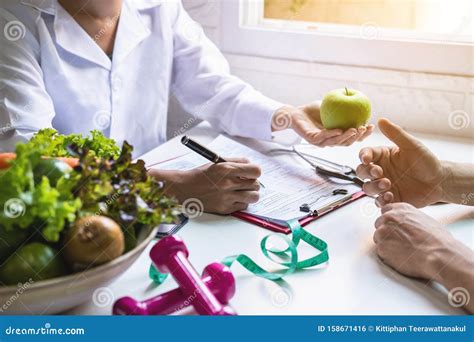 Nutritionist Giving Consultation To Patient With Healthy Fruit And