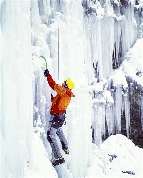 Man Climbing Frozen Waterfall Stock Image Image Of Determination