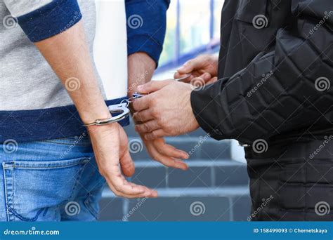 Police Officer Putting Handcuffs on Criminal, Closeup Stock Image ...