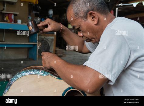 Gianyar Bali Indonesia May 30 2019 A Guitar Craftsman Are Carving A Classical Guitars Made From