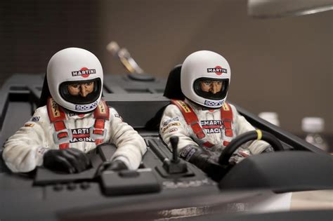 Two Toy Race Drivers Sitting In The Driver S Seat