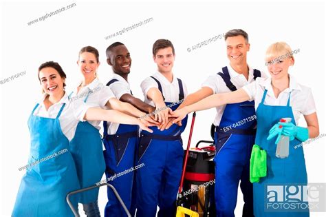 Group Of Happy Janitors Stacking Hands Isolated On White Background