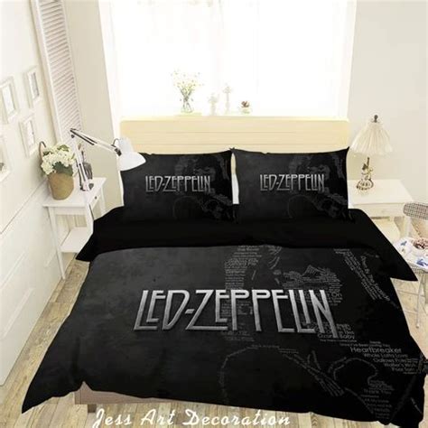 a bed with black comforters and pillows in a room