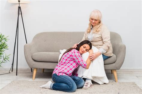 Free Photo Young Woman Lying On Her Mothers Lap In The Living Room