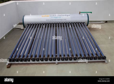 Solar Thermal Water Heating System With Tank And Evacuated Tubes On Roof Of House Kenya Stock