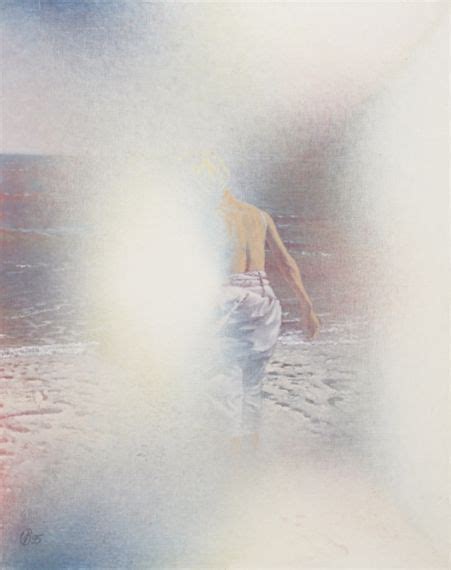 A Man Walking On The Beach Next To The Ocean