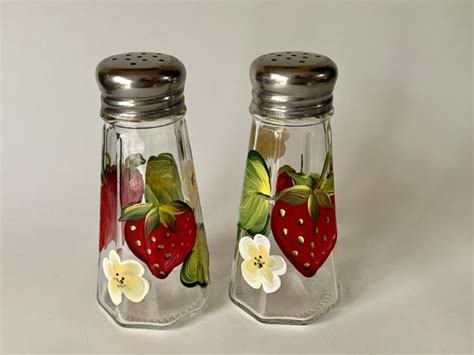 Two Glass Salt And Pepper Shakers Decorated With Strawberries