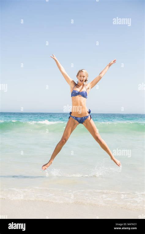 Carefree Woman In Bikini Jumping On The Beach Stock Photo Alamy