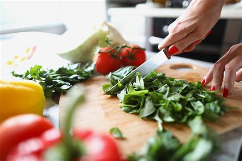 Premium Photo Female Hands Cut Lettuce Leaves With A Kitchen Knife On