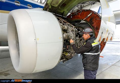 a man working on an airplane engine