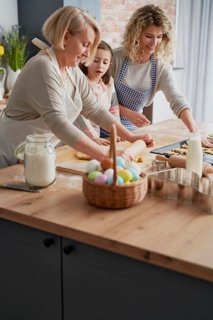 Premium Photo Grandmother Teaching Granddaughter How To Make Easter Cake