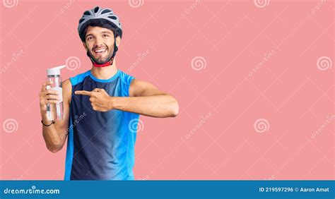 Handsome Hispanic Man Wearing Bike Helmet And Holding Water Bottle