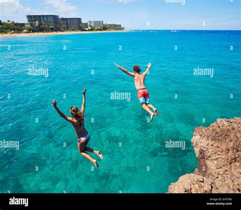 Summer Fun Friends Cliff Jumping Into The Ocean Stock Photo Alamy