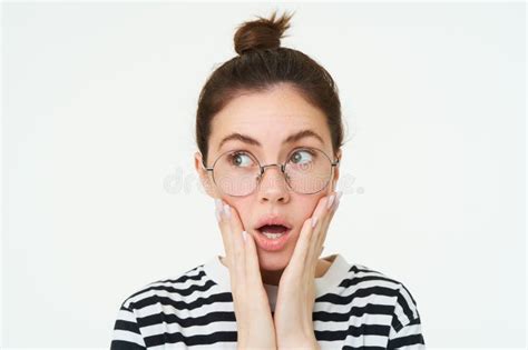 Image Of Shocked Woman In Glasses Holds Hands On Face Gasps And Looks