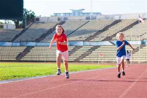 Child Running in Stadium. Kids Run. Healthy Sport Stock Photo - Image ...