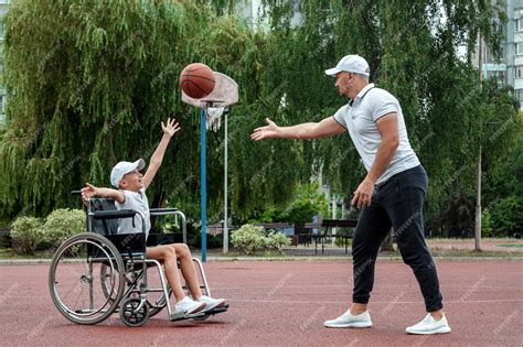 Premium Photo Dad Plays With His Disabled Son On The Sports Ground