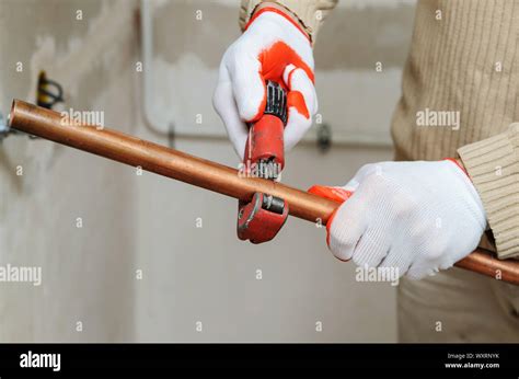 worker    copper pipe cutter  cut  pipes