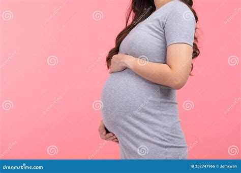 Side View Close Up Pregnant Woman Standing Stroking Big Belly With Love On Pink Background