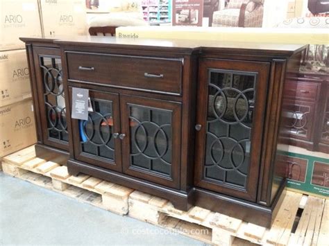 A Wooden Sideboard With Glass Doors On Display In A Store Or Showroom