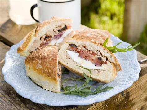 Pan Bagnat is a hollowed out roll filled with salad Nicoise. It is a ...