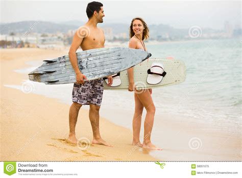 Young Surfers Couple On The Beach Stock Image Image Of Beach Board