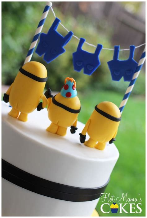 A Cake With Some Decorations On It In The Shape Of Cartoon Characters