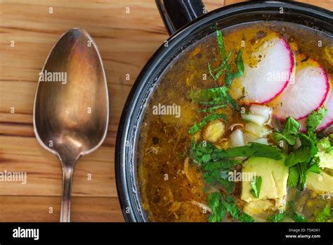 Authentic Mexican Pozole Soup With Avocado Cilantro And Radish Garnish