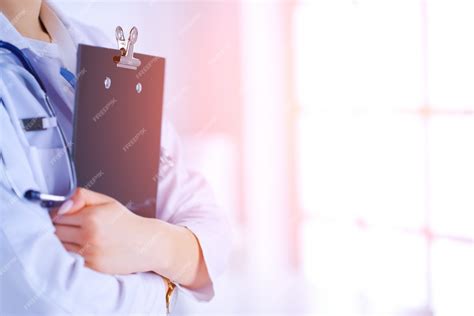 Premium Photo Female Doctor In The Office With Folder In Her Hands