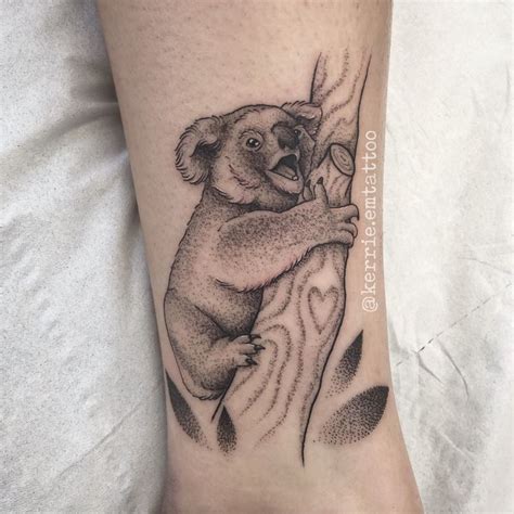 a black and white koala bear tattoo on the leg