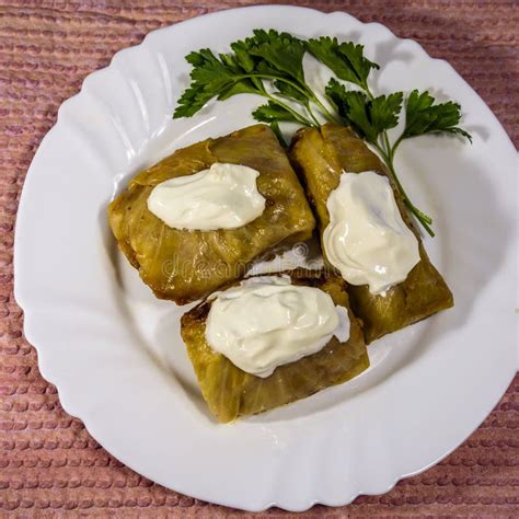 Cabbage Rolls with Rice, Wrapped in Cabbage Leaves and Under Sour Cream ...