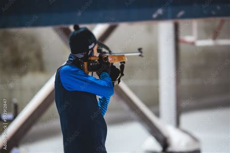 Biathlete with rifle on a shooting range during biathlon training ...