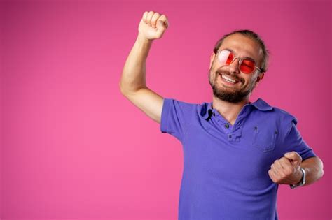 Premium Photo Overjoyed Funny Bearded Man In Glasses Celebrating Success