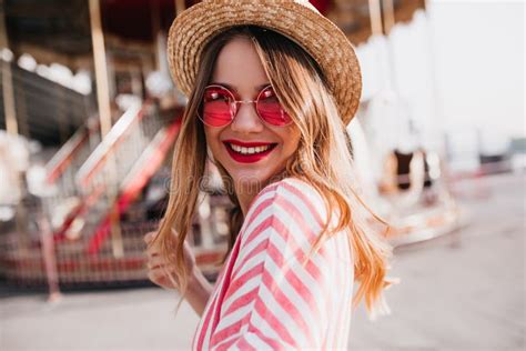 Outdoor Portrait Of Smiling Adorable Woman In Straw Hat Looking Over