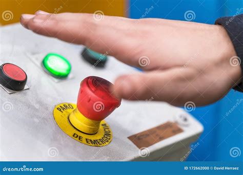 Hand Pressing The Red Emergency Button Or Stop Button For Industrial