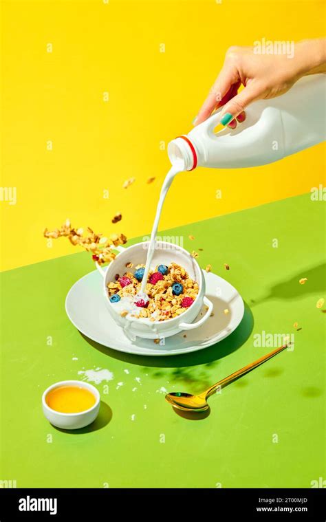 Healthy Breakfast Woman Pouring Milk Into Bowl With Delicious Muesli Cereal With Berries